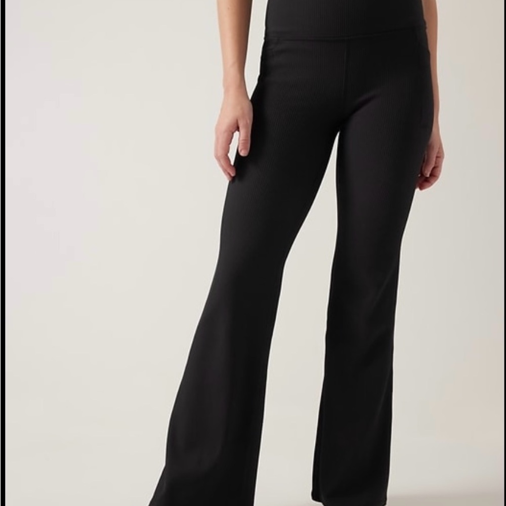 Black Athleta Salutation Stash ribbed flare leggings. Size XS